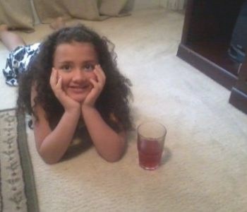 Girl with drink on carpet
